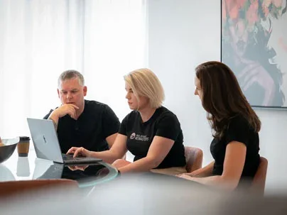 Morgan Carey and Amy Pye working with laptop